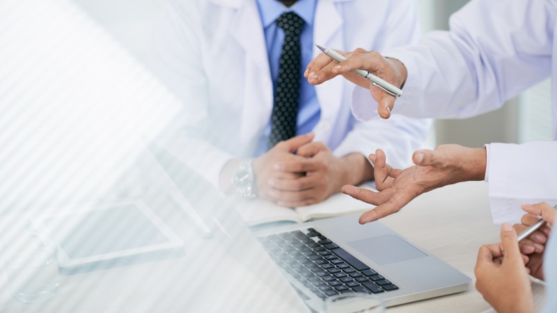 Hands of medical workers having discussion in the office